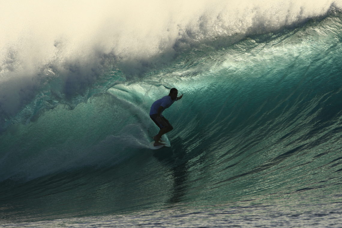 surfing a perfect barrel wave