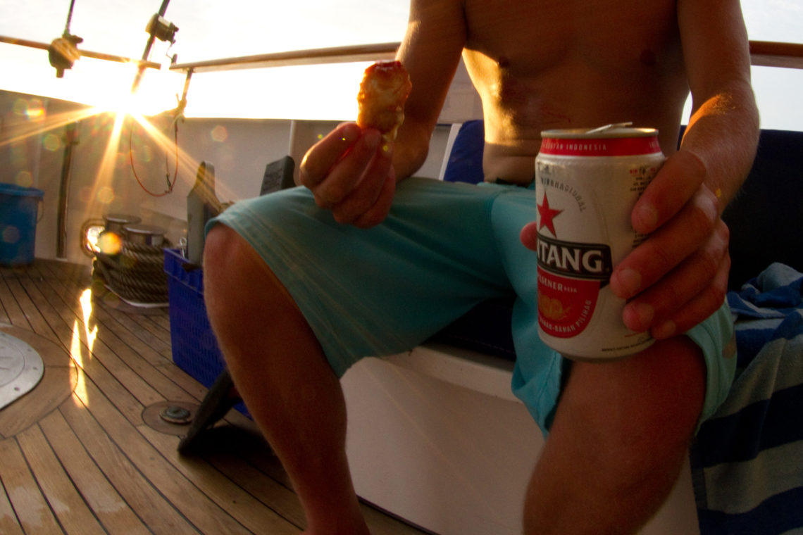 Eating and drinking Bintang aboard Mentawais surf charter
